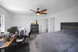Carpeted bedroom featuring visible vents and ceiling fan