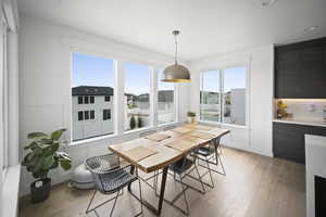 Dining area with light wood-style floors