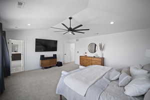Bedroom with vaulted ceiling, a ceiling fan, visible vents, and light carpet