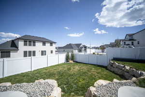 View of yard featuring a residential view and a fenced backyard