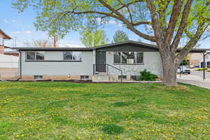 Ranch-style home featuring brick siding and a front yard