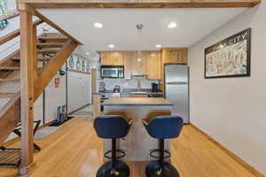 Kitchen with recessed lighting, appliances with stainless steel finishes, a sink, and light wood-style floors