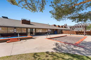 Exterior space featuring fence, a patio area, and a community pool