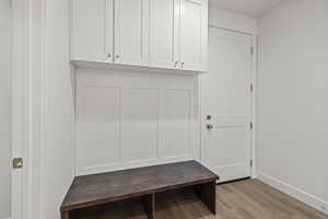 Mudroom with baseboards and wood finished floors