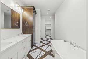 Full bath featuring marble finish floor, a freestanding bath, baseboards, visible vents, and recessed lighting