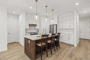 Kitchen with recessed lighting, light countertops, a sink, tasteful backsplash, and appliances with stainless steel finishes