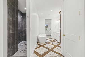 Bathroom with marble finish floor, a soaking tub, a walk in shower, and recessed lighting