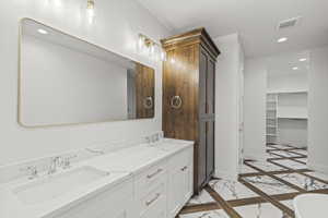 Full bath with visible vents, a sink, and recessed lighting