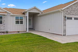 View of front of property featuring board and batten siding, stone siding, and a shingled roof