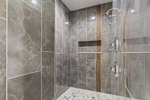 Full bath featuring a tile shower