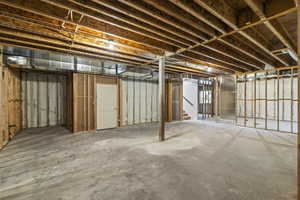 Unfinished basement featuring stairway