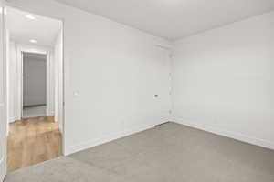 Unfurnished room featuring baseboards, recessed lighting, and light colored carpet