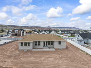 Rear view of house with a residential view, fence, and a mountain view