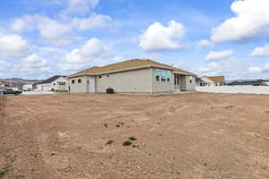 Back of property with a residential view, central AC, and fence