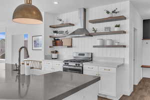 Kitchen featuring custom cabines; open shelves; exhaust hood; & finish carpentry.