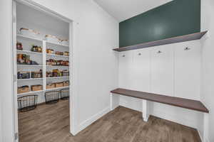 Mudroom with built in hooks, shelf, seat & shoe storage.