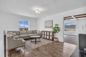 2nd level family room area with a healthy amount of sunlight and wood finished floors