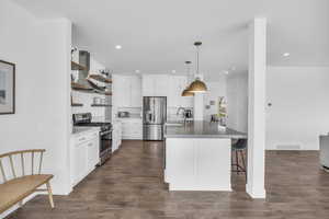 Kitchen featuring custom cabines; open shelves; exhaust hood; & finish carpentry.