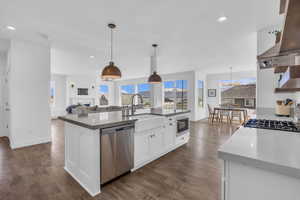 Custom Kitchen featuring stainless steel appliances, island exhaust hood, and farmhouse sink