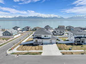 Drone / aerial view with a water and mountain view and a residential view