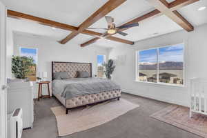 Master Bedroom w/ custom beamed ceiling, large windows & commanding lake & mountain view.