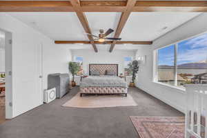 Master Bedroom w/ custom beamed ceiling, large windows & commanding lake & mountain view.