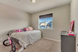 Bedroom featuring carpet floors and baseboards
