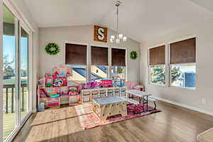 Sunroom / solarium with plenty of natural light and a notable chandelier