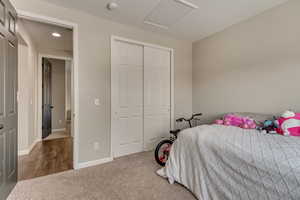 Bedroom with recessed lighting, a closet, baseboards, attic access, and carpet flooring