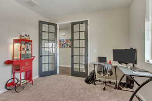 Home office with carpet floors, french doors, visible vents, and baseboards