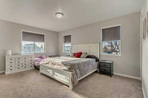Carpeted bedroom featuring baseboards