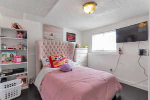 Bedroom featuring wood finished floors and a textured ceiling