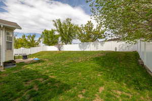 View of yard with a fenced backyard and a patio area