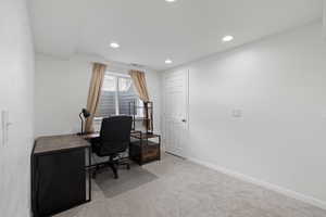 Office with recessed lighting, carpet floors, visible vents, and baseboards