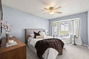 Bedroom featuring baseboards, carpet, and ceiling fan