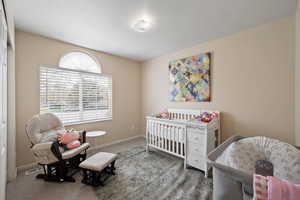 Bedroom featuring visible vents, carpet flooring, and baseboards