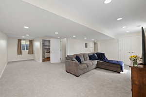 Living room with recessed lighting, baseboards, and light carpet