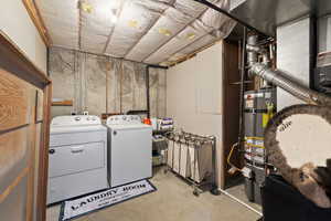 Washroom with secured water heater, separate washer and dryer, and laundry area
