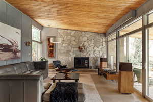 Living area with wood ceiling, a wealth of natural light, and finished concrete floors