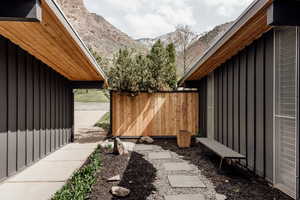 Exterior space featuring board and batten siding, fence, and a mountain view