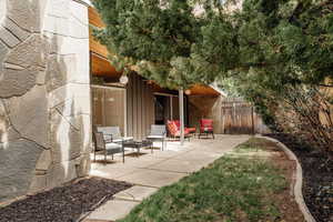 View of yard featuring fence and a patio area