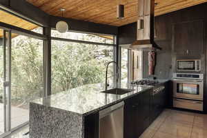 Kitchen with wood ceiling, a sink, appliances with stainless steel finishes, and a warming drawer