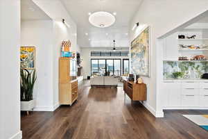Hallway featuring recessed lighting, dark wood finished floors, and baseboards