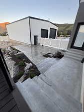 View of patio / terrace with a garage, entry steps, and a mountain view
