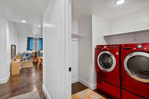 Clothes washing area featuring laundry area, baseboards, washer and dryer, and recessed lighting