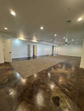 Basement with recessed lighting, and ceiling fan