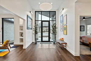 Foyer with recessed lighting, a high ceiling, dark wood-type flooring, baseboards, and ceiling fan