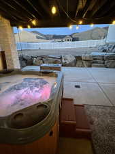 View of patio featuring a hot tub.