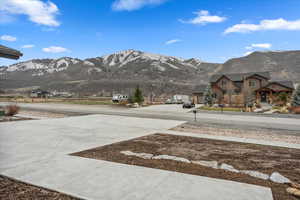 View of road with concrete driveway and a mountain view