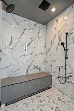 Full bathroom featuring a marble finish shower and recessed lighting